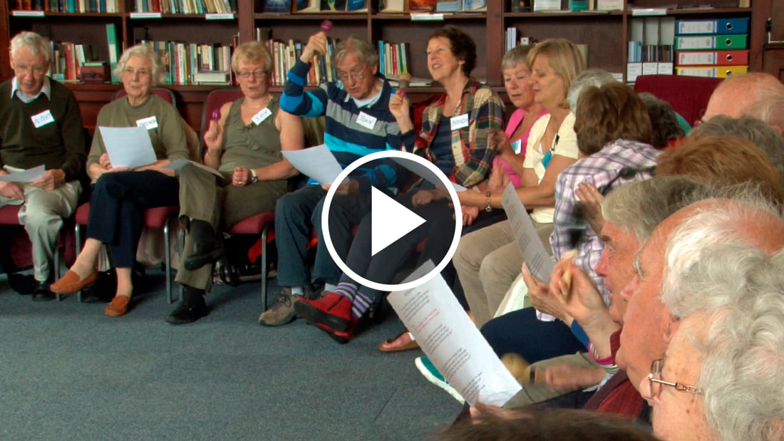 People singing at Alzheimer's support group. Click to view videos for Non-Profit organisations.